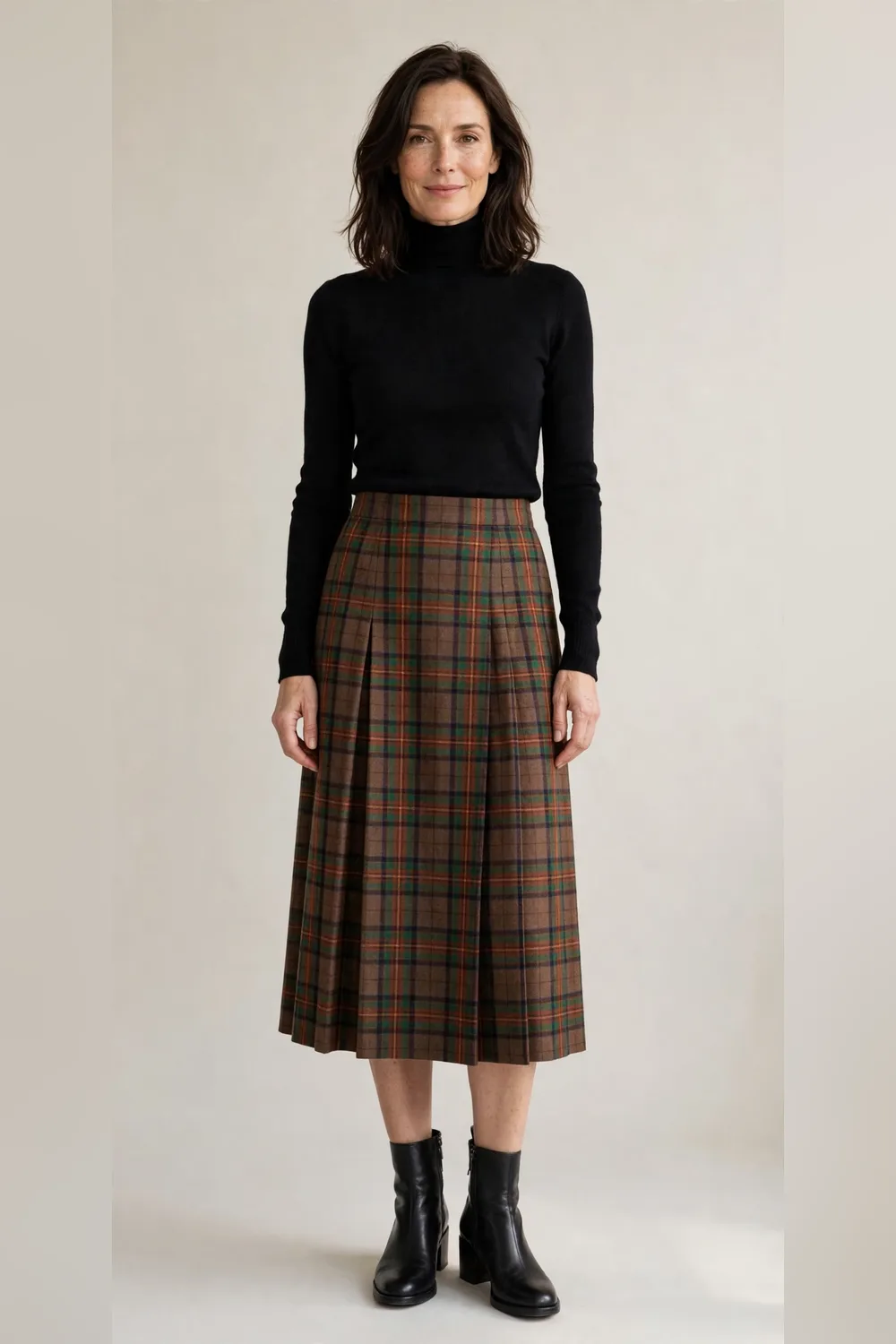 Tartan midi skirt with a black turtleneck and black boots for Christmas dinner