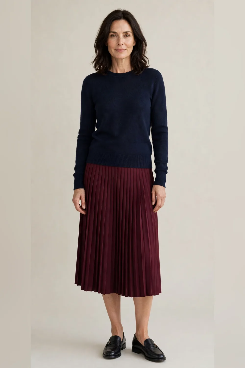 Burgundy pleated skirt with a navy sweater and loafers for Christmas dinner