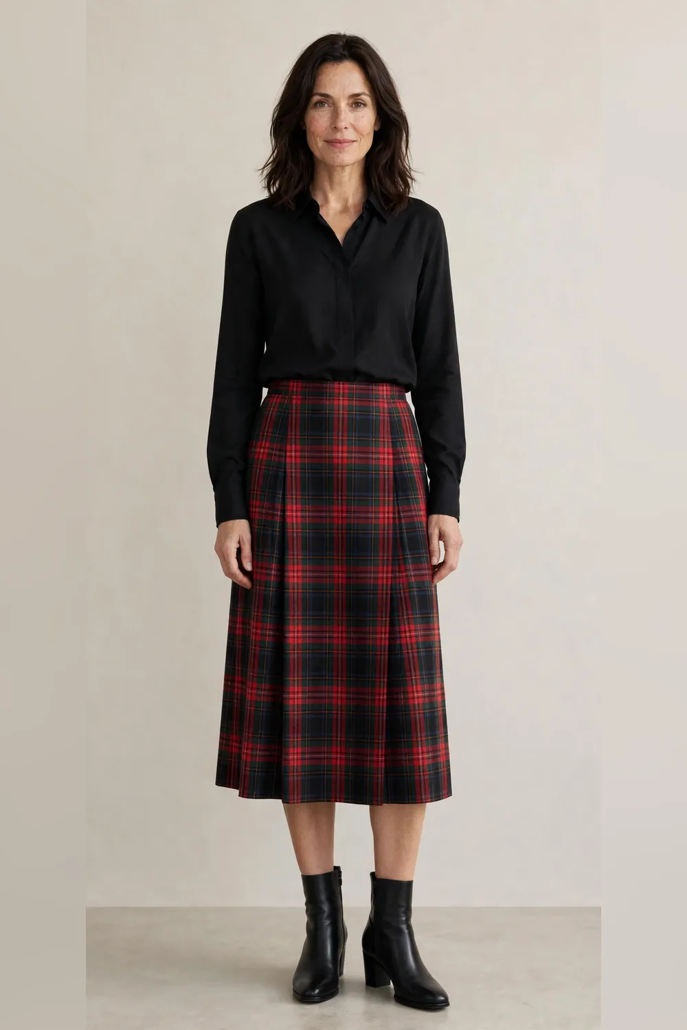 Tartan midi skirt with a black blouse for an office Christmas party