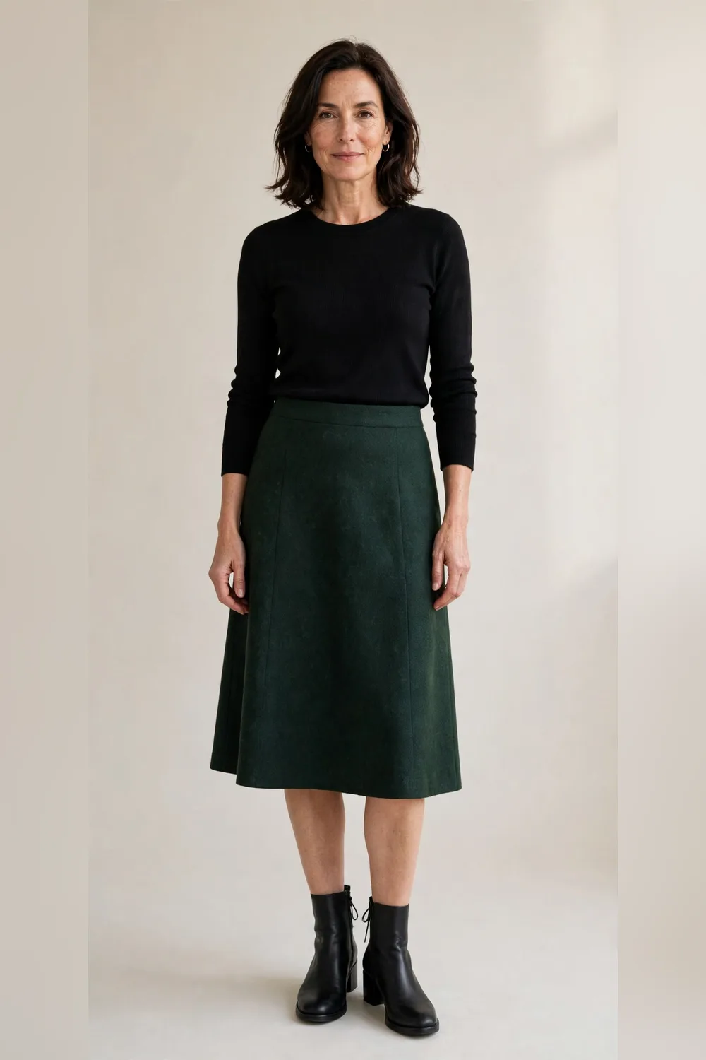 Dark green wool skirt with a black knit top for an office Christmas party