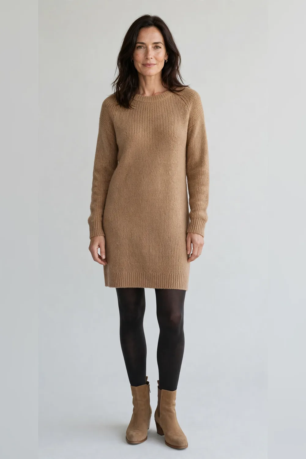 Camel knit dress with dark tights and tan ankle boots for an office Christmas party