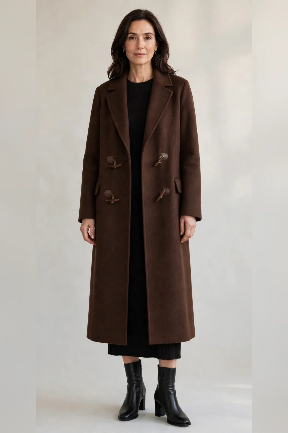 Chocolate maxi wool coat over a black midi dress with heeled boots