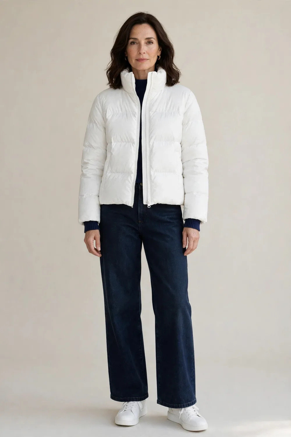 Short white puffer coat with dark wide-leg jeans and white sneakers