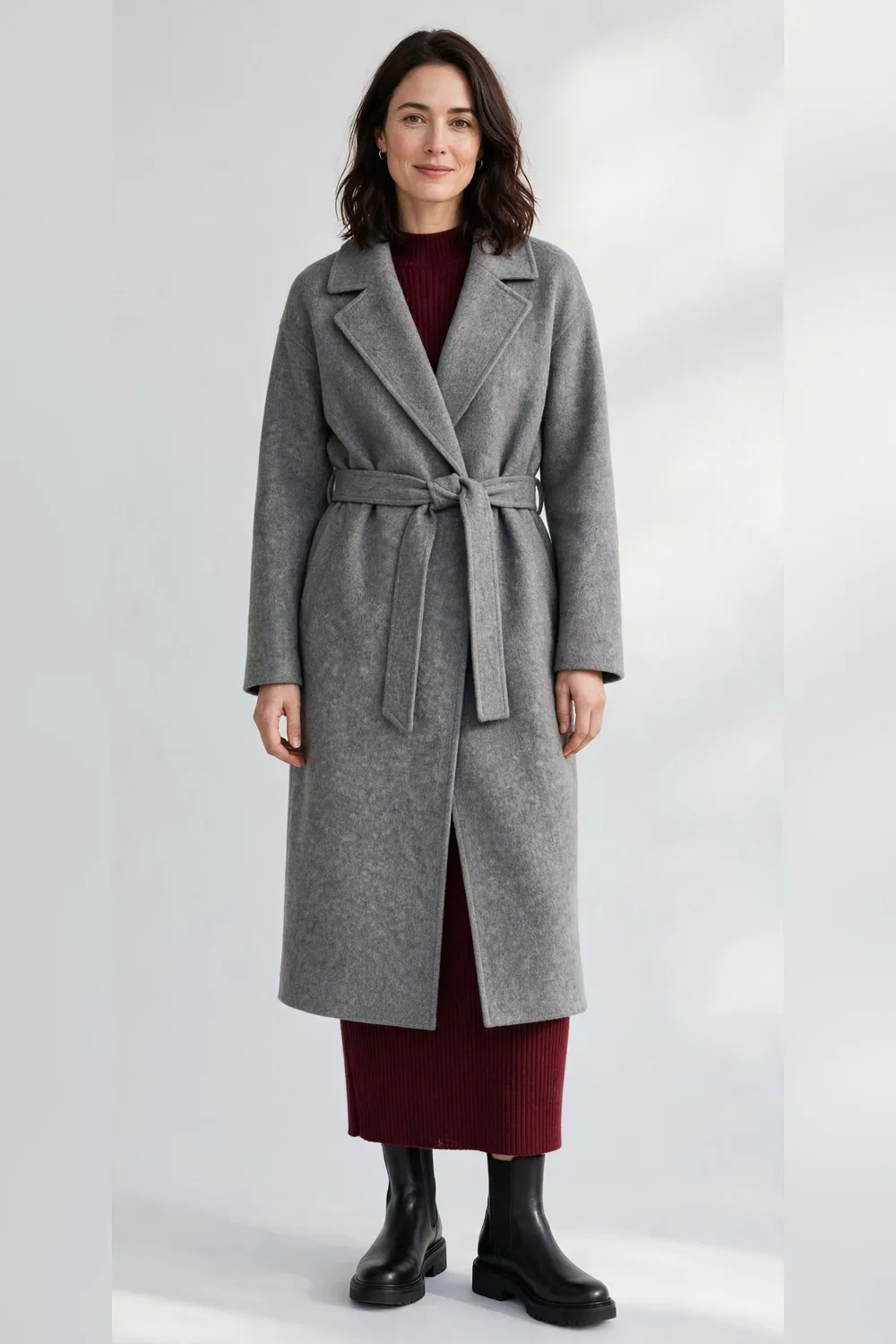 Grey wool wrap coat over a burgundy knit dress with black ankle boots for women in their 30s