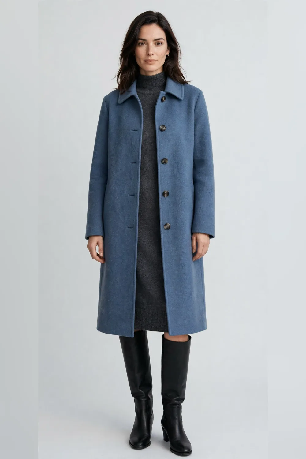 Dusty blue wool coat over a charcoal knit dress with black boots for women in their 30s