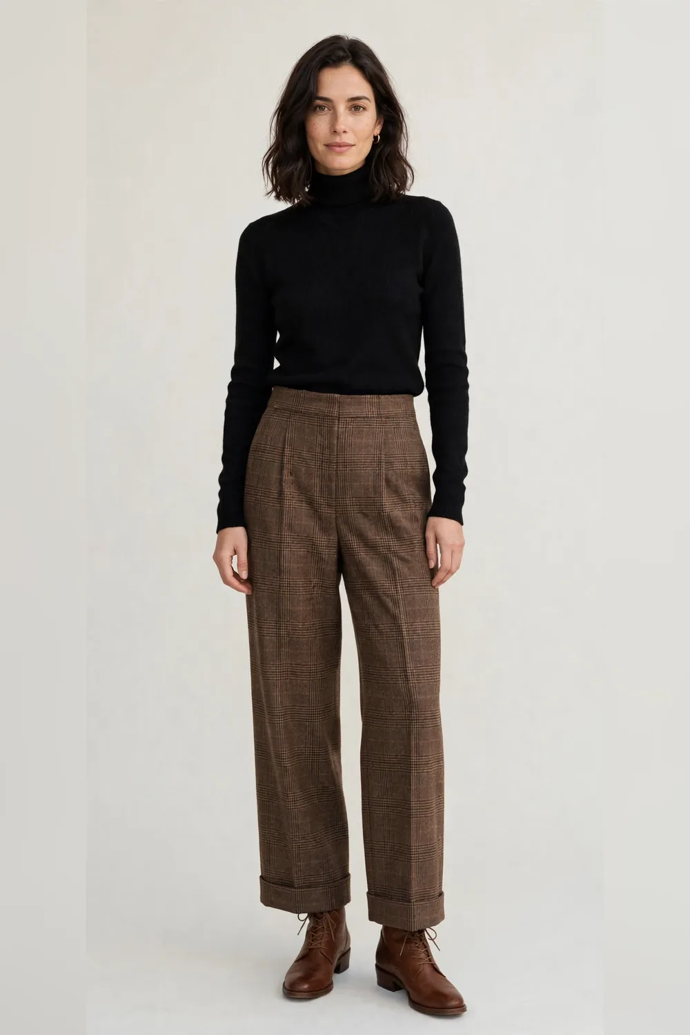 Black turtleneck with brown check wide-leg trousers and brown ankle boots for women in their 30s